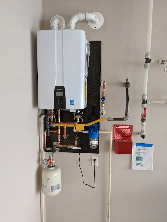 Professional plumber installing copper piping in a Hanson home